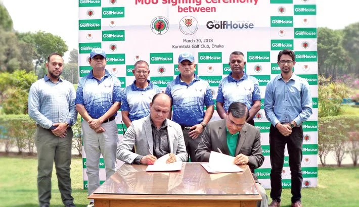Group photo during Memorandum of Understanding signing ceremony at Kurmitola Golf Club, Dhaka. Two men are seated at a table signing documents, with several individuals standing behind them. The backdrop features logos and the date March 30, 2018.